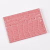 A pink crocodile embossed slim PU leather card holder wallet for women.