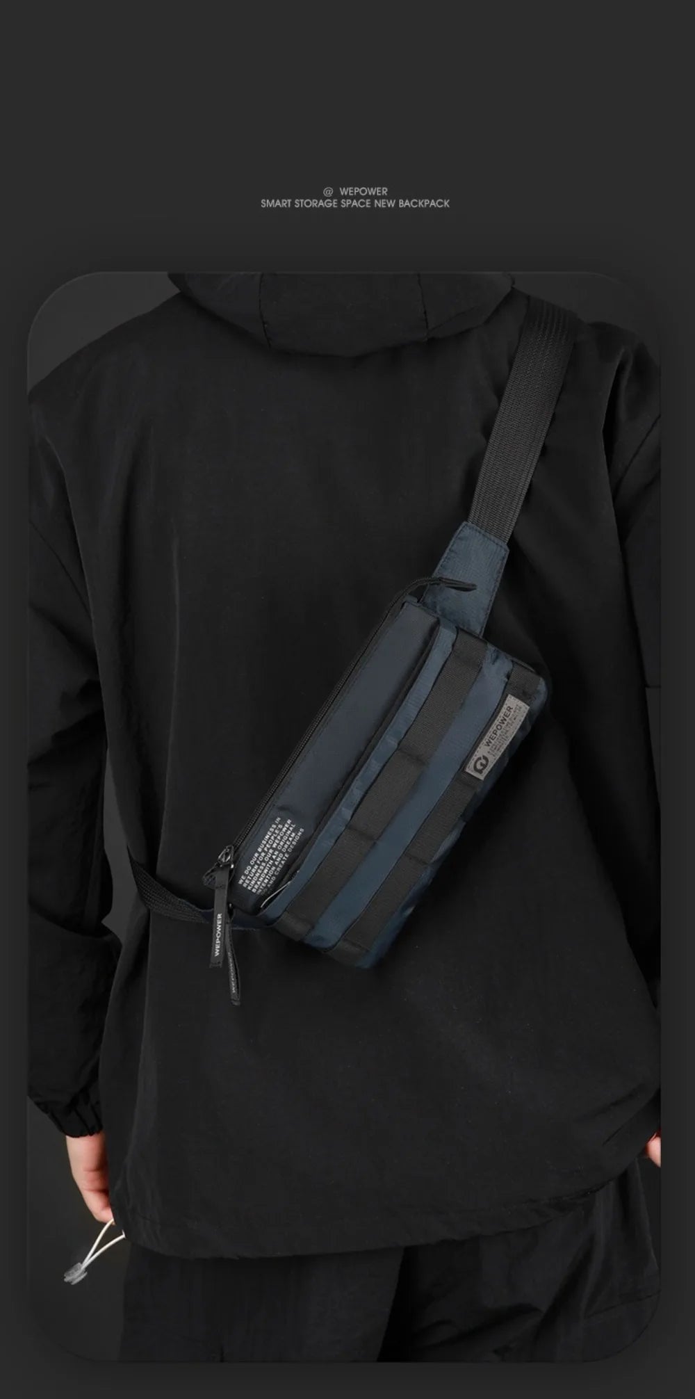 A dark gray chest bag is worn across the torso of a person in a black long-sleeved shirt.