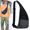 Black versatile crossbody sling bag worn by a person in an orange shirt and camouflage pants.