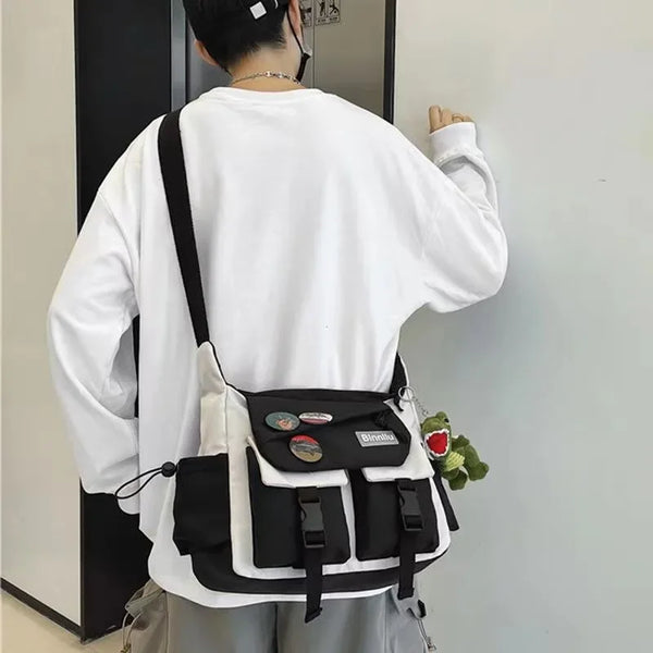 A woman is shown from the back wearing a white long-sleeved shirt and a black and white nylon crossbody shoulder bag.