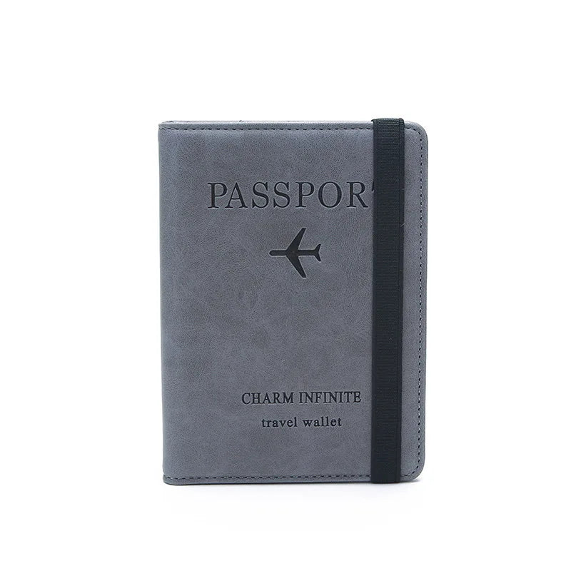 A dark gray passport holder with black trim and a silver airplane logo on the cover.