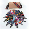 A collection of colorful patterned adjustable crossbody straps and a beige leather wallet.