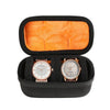 Black watch organizer case with an orange soft lining and a watch slot.