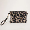 A black and brown leopard print faux leather wrist bag with a gold chain strap.