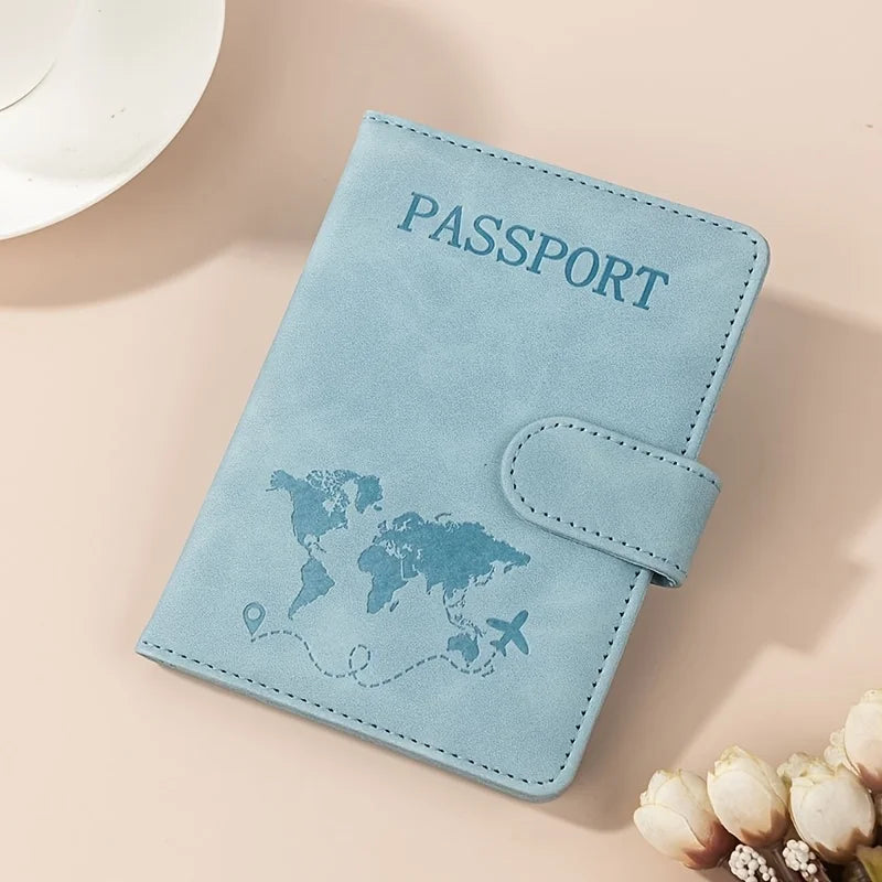 A light blue passport wallet with a leather texture and a flap, featuring a world map design.