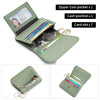 A green leather slim tri-fold wallet with a zipper coin pocket, card slots, and a driver's license holder.