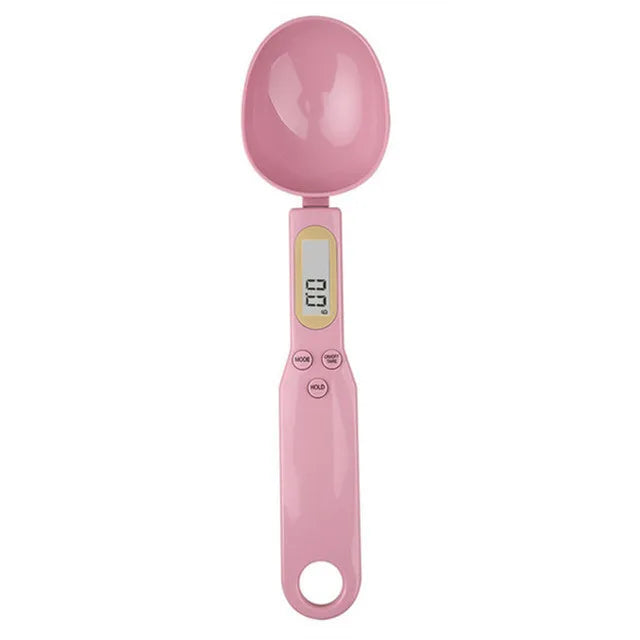 A pink precision digital kitchen scale with a round weighing platform and a digital display.
