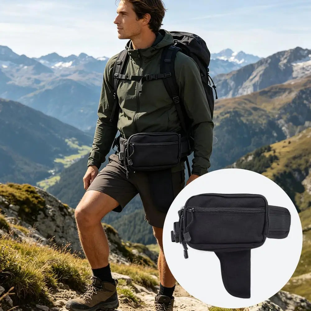 A man wearing a tactical concealed carry waist pack while hiking in a mountainous outdoor setting.