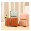 A set of three leather bags in mint green, tan, and blush pink displayed on a light wooden surface.