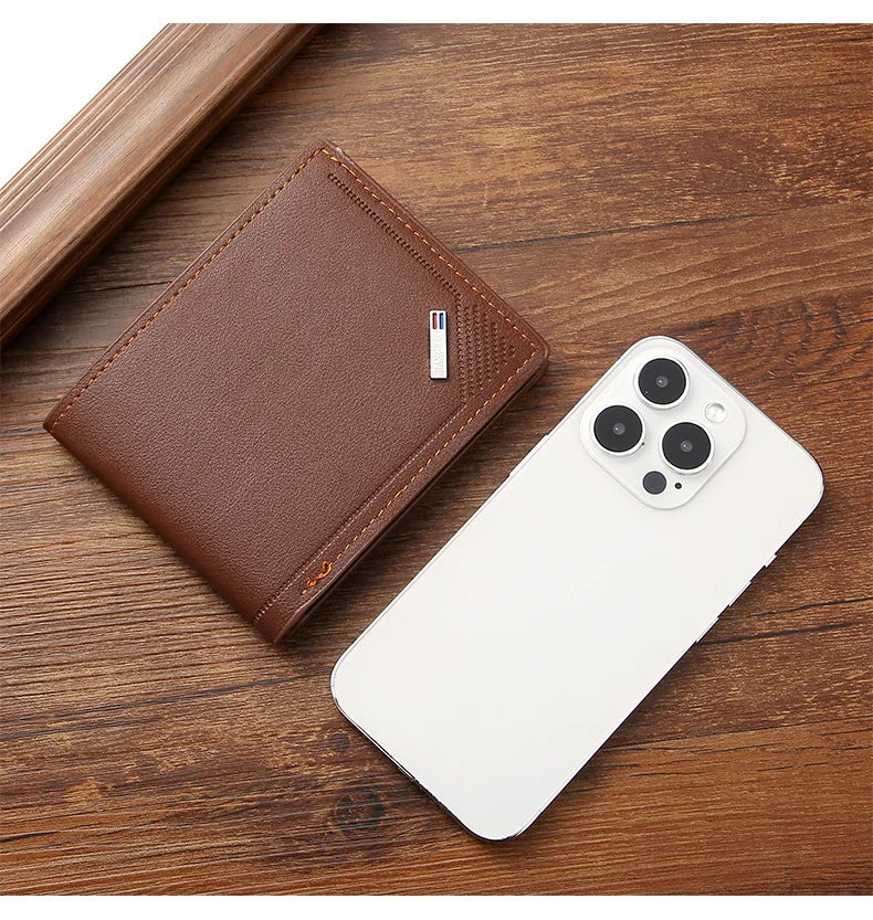 A brown leather wallet with a money clip resting on a wooden surface next to a white smartphone.