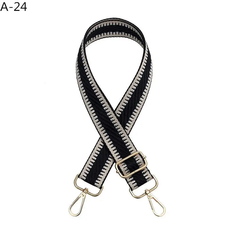 Black and white striped adjustable crossbody strap with gold-toned hardware