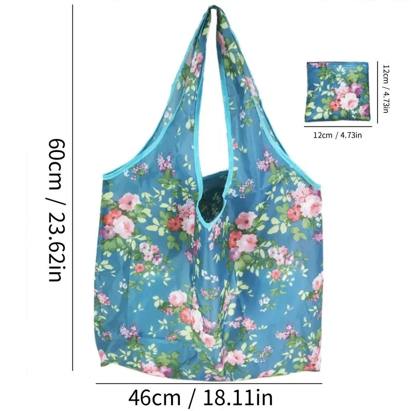 A teal floral reusable shopping bag with a wide opening and a matching fabric swatch shown next to the product.