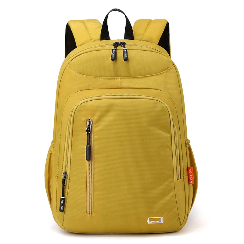 A yellow fashion commuter daypack for women with black accents and zippered compartments.