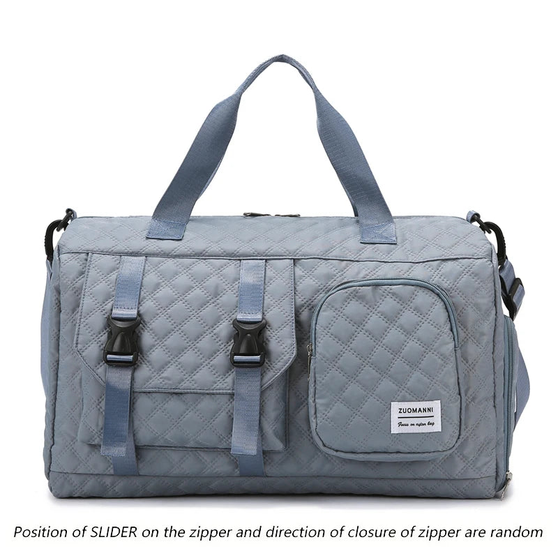 A light gray nylon travel duffle bag with a quilted pattern and blue straps.