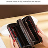 A brown vintage PU leather zippered wallet with multiple compartments is held in a hand on a light surface.
