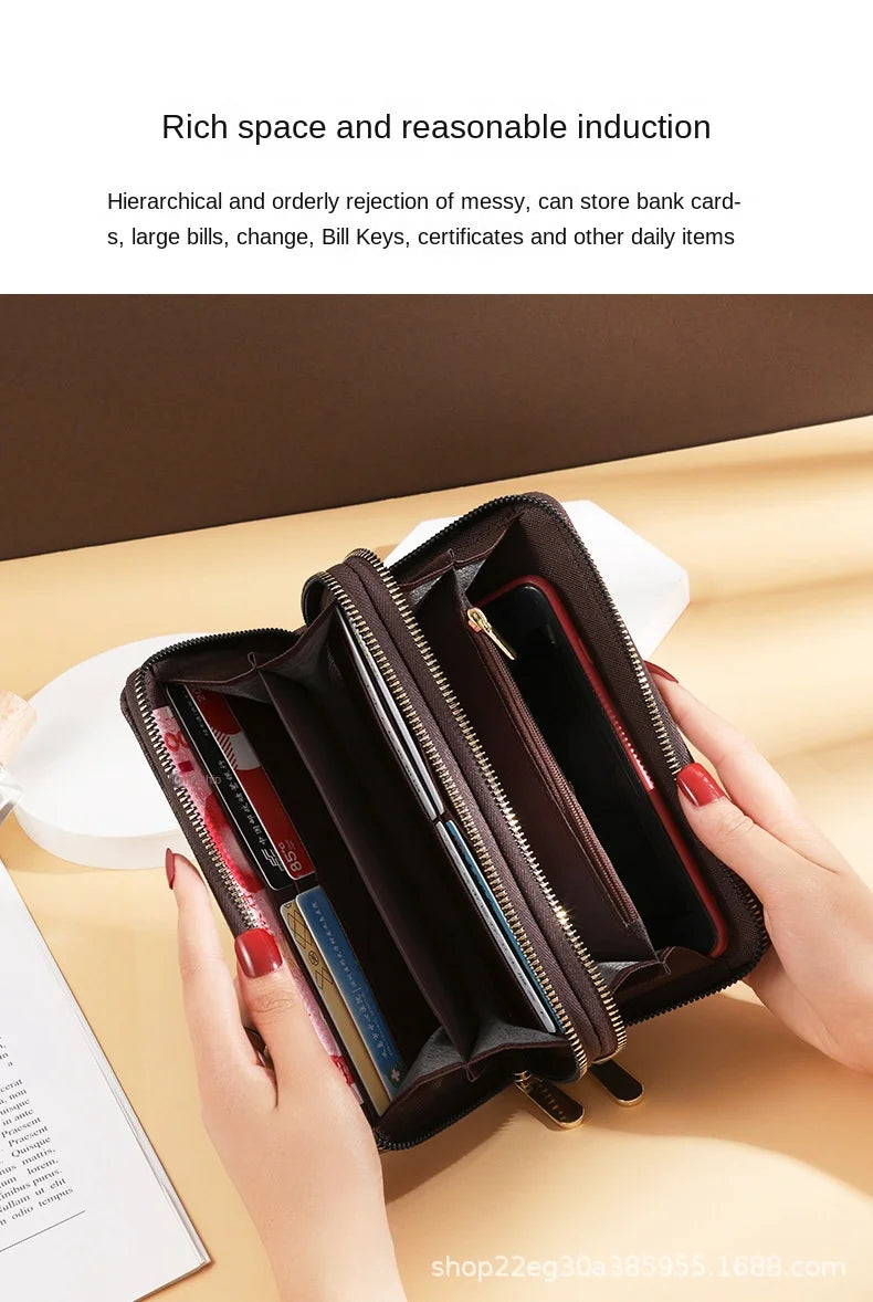 A brown vintage PU leather zippered wallet with multiple compartments is held in a hand on a light surface.