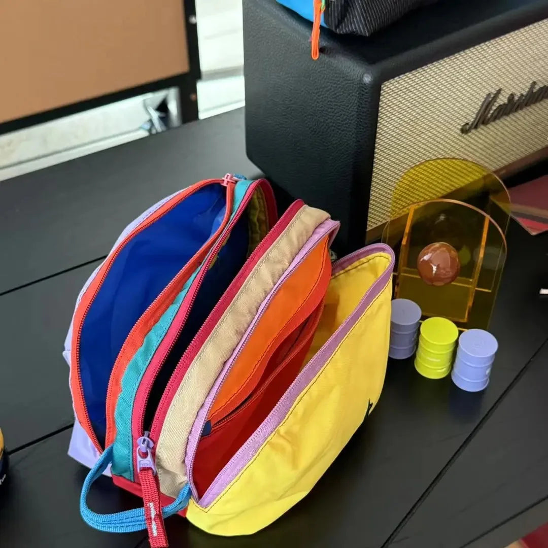 A collection of lightweight travel makeup bags in various dopamine colors, including blue, orange, pink, and yellow.