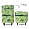 A lime green folding shopping trolley bag with a floral pattern, shown from the side.