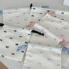 A collection of white canvas makeup bags featuring light blue and pink bowknot designs.