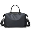 A dark gray durable nylon travel duffle bag with black leather trim and carrying handles.