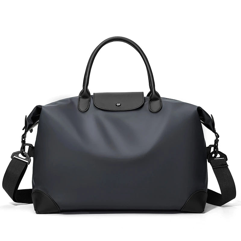 A dark gray durable nylon travel duffle bag with black leather trim and carrying handles.