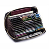 A black leather RFID women's travel wallet with a zipper closure, filled with various credit cards and cash.