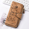 A brown leather zippered coin purse featuring a line drawing of a sleeping bear and a butterfly.
