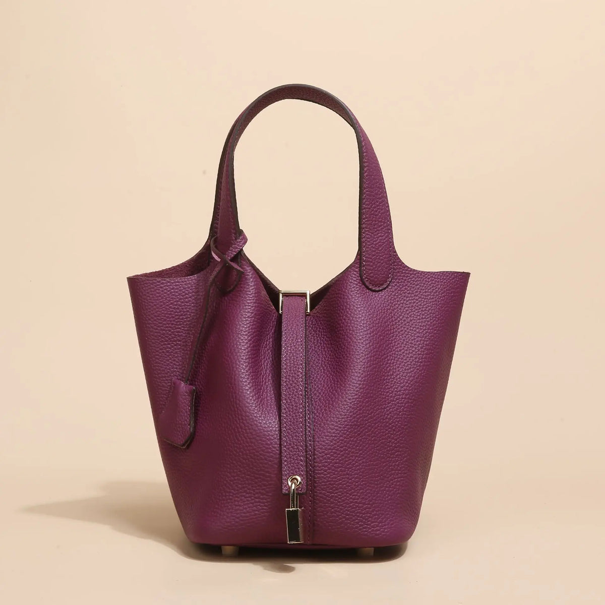 Tiefviolette, echte Leder-Bucket-Bag mit Schnurverschluss und goldfarbener Hardware.