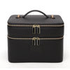 Black double-layer makeup storage case with gold accents and zipper closures