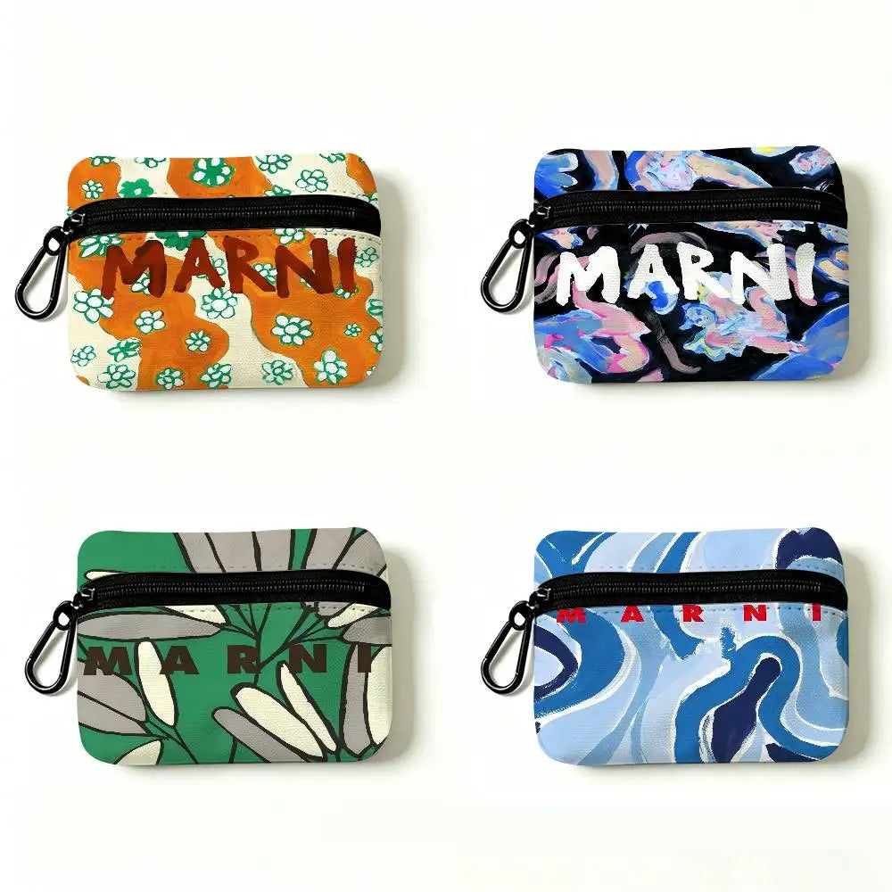 Two versions of a floral print mini coin purse with carabiner clips, one in orange and green and one in blue and black.
