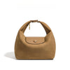 A tan nylon dumpling crossbody shoulder bag with a flap closure and gold hardware.