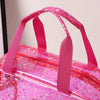 A pink clear waterproof makeup organizer bag with pink straps and glitter accents.