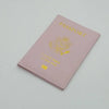 A pink leather passport holder with gold foil printing of the United States of America eagle design.
