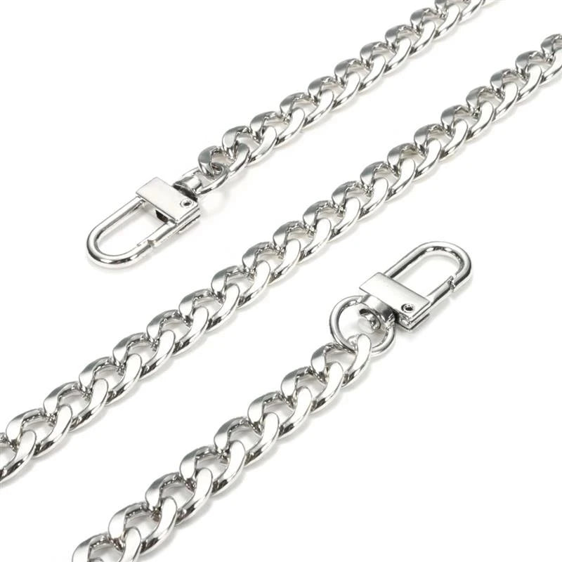 A close-up view of a stainless steel diamond-cut curb chain bag strap.
