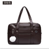 A dark brown leather shoulder bag with a padded design and a white fluffy accent.