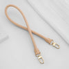 A light tan genuine vachetta leather bag strap with brass hardware shown against a white background.