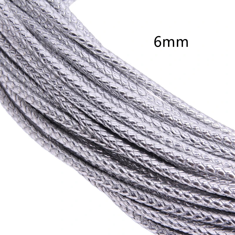 Close-up of a silver braided leather cord, 6mm in diameter.