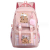 A pink canvas backpack featuring a cute capybara design with a fluffy pink pom-pom.