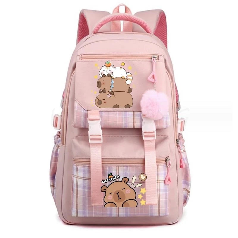 A pink canvas backpack featuring a cute capybara design with a fluffy pink pom-pom.