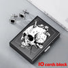 A black slim card holder featuring a detailed skull design and silver-toned card clips.
