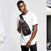A man wearing a white t-shirt holds a brown PU leather crossbody sling bag.