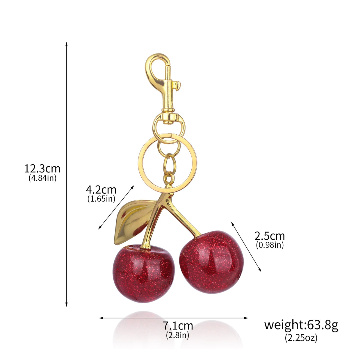 A gold-colored crystal cherry fruit keychain with a hanging loop and a red, glittery cherry sphere.