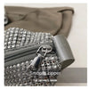 Close-up of a silver rhinestone-embellished crossbody bag with a gray adjustable strap and zipper detail.
