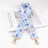 A light blue and white patterned diagonal fabric strap used as an adjustable shoulder strap for bags.