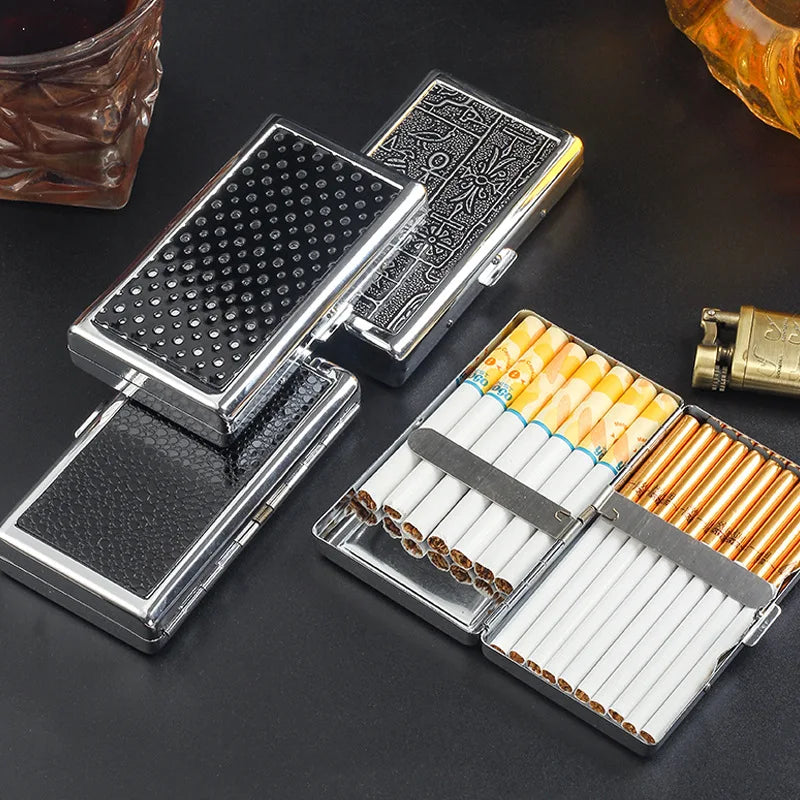 A metal cigarette case holder with a textured black surface and a compartment for cigarettes is displayed on a dark backgroun