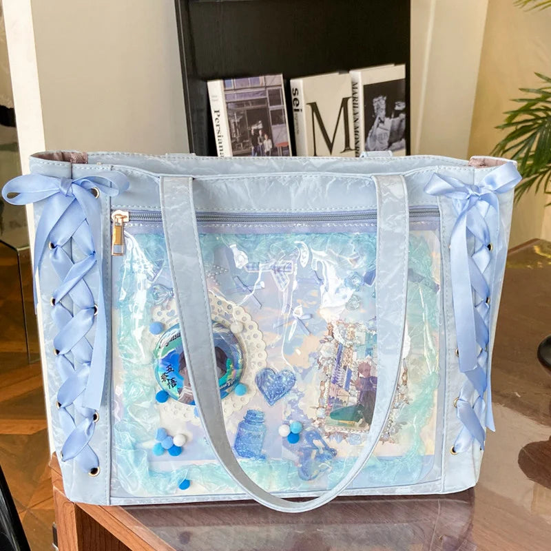 A light blue transparent shoulder tote bag with decorative ribbons and blue accents.