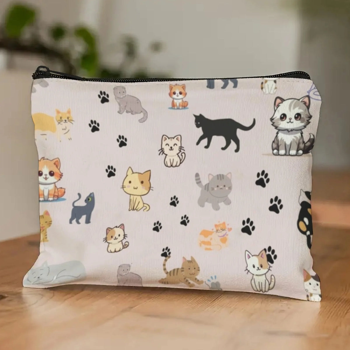 A white zippered pouch filled with cartoon cat illustrations, featuring various feline characters and paw prints.