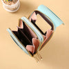 A light blue luxury women's crossbody shoulder bag with gold zippers and pink accents.