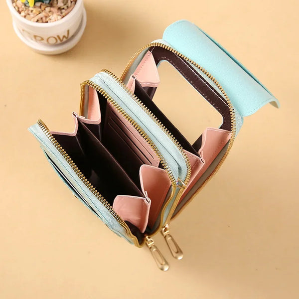 A light blue luxury women's crossbody shoulder bag with gold zippers and pink accents.