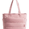 A soft pink quilted tote bag with a fabric handle is shown against a white background.